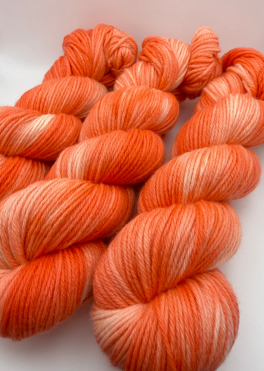 Hand dyed yarn UK available in 4ply sock, aran, DK in Grapefruit Twist colourway – Coral and Citrus tones.