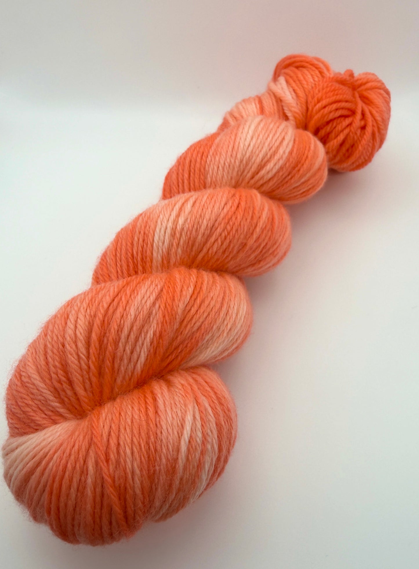 Hand dyed yarn UK available in 4ply sock, aran, DK in Grapefruit Twist colourway – Coral and Citrus tones.