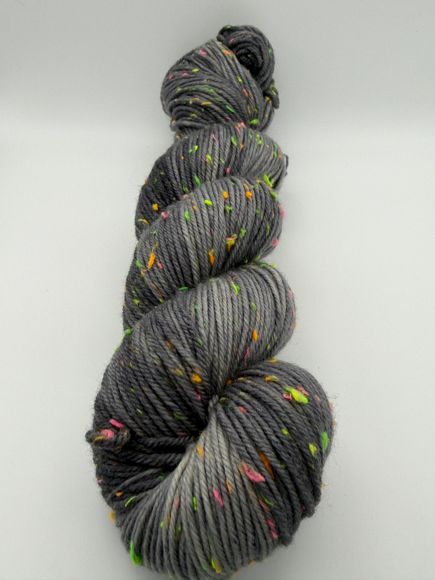 Hand dyed yarn in the UK dyed in small batches. Neon Dust, grey tones with neo nep speckles.