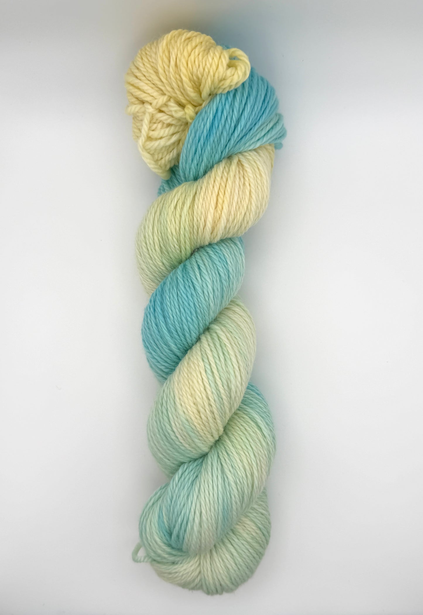Hand dyed yarn UK available in 4ply sock, aran, DK in Honeydew Sky colourway – Lemon and Blue tones.