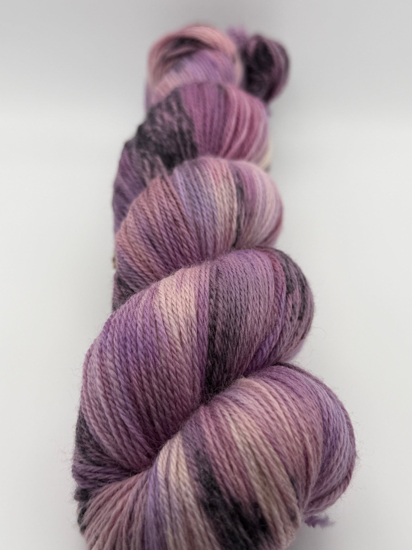 Hand dyed yarn in the UK dyed in small batches. Lilac Skies, purple violet and heather tones.