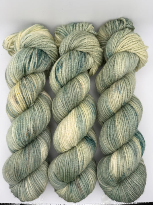 Hand dyed yarn available in 4ply sock, DK, Aran in Mellow Sage colourway – greens and neutral tones. Speckled yarn.