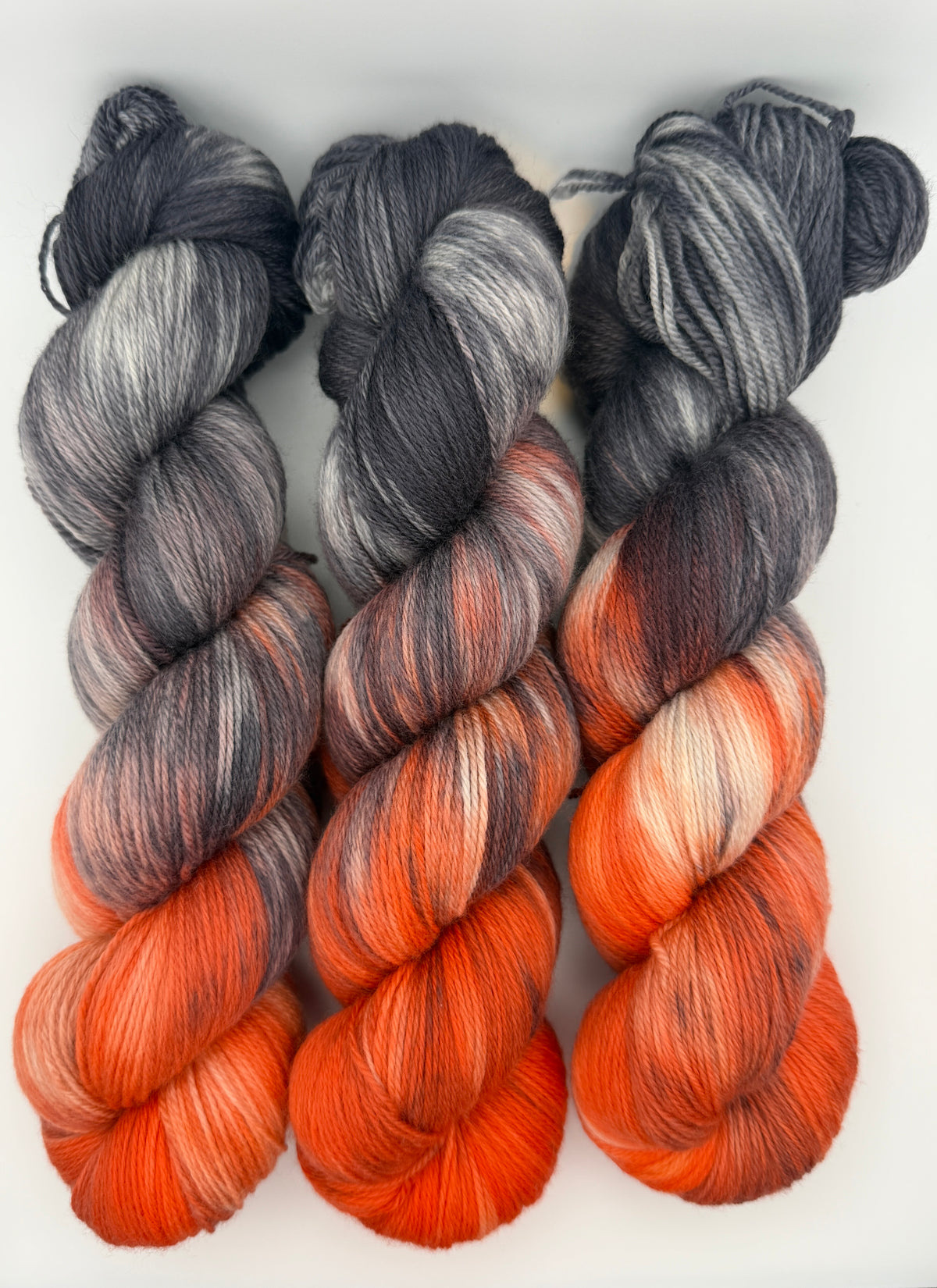 Hand dyed yarn uk, yarn dyed in small batches, Ashes & Embers available in Aran, DK 4 ply, sock, double knit, red, orange, grey tones.