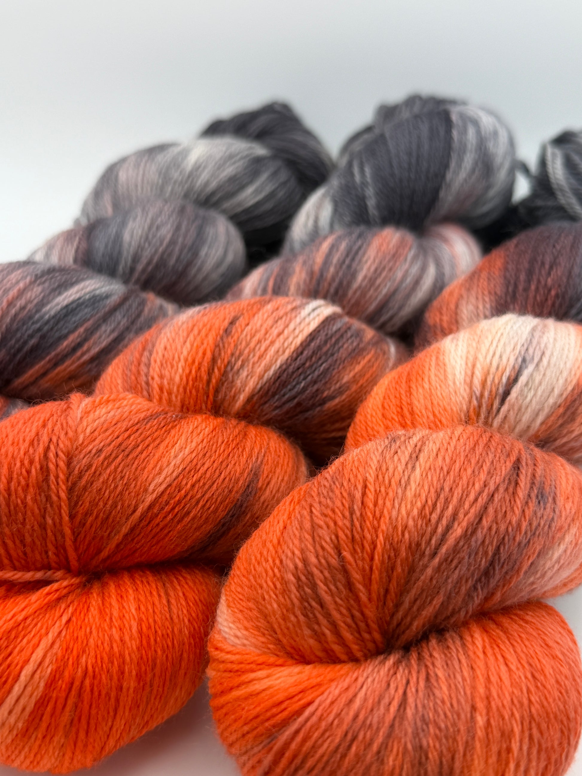 Hand dyed yarn uk, yarn dyed in small batches, Ashes & Embers available in Aran, DK 4 ply, sock, double knit, red, orange, grey tones.