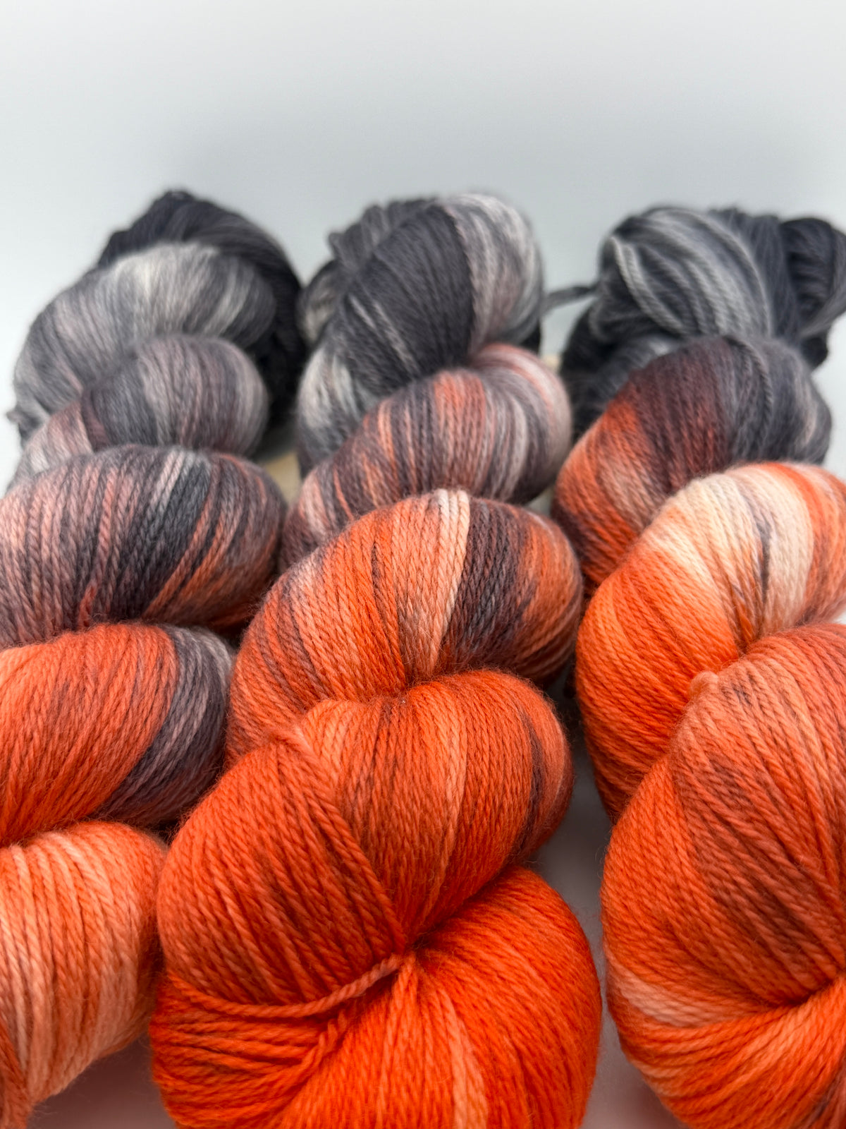 Hand dyed yarn uk, yarn dyed in small batches, Ashes & Embers available in Aran, DK 4 ply, sock, double knit, red, orange, grey tones.