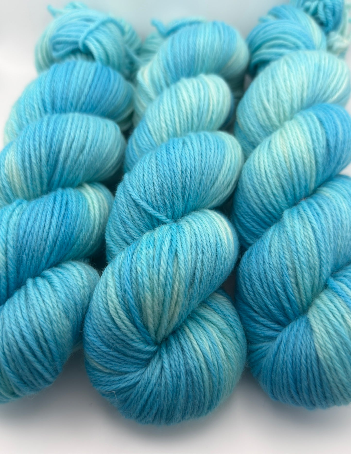Hand dyed yarn UK available in 4ply sock, aran, DK in Blue Lagoon colourway – blue, teal, aqua tones