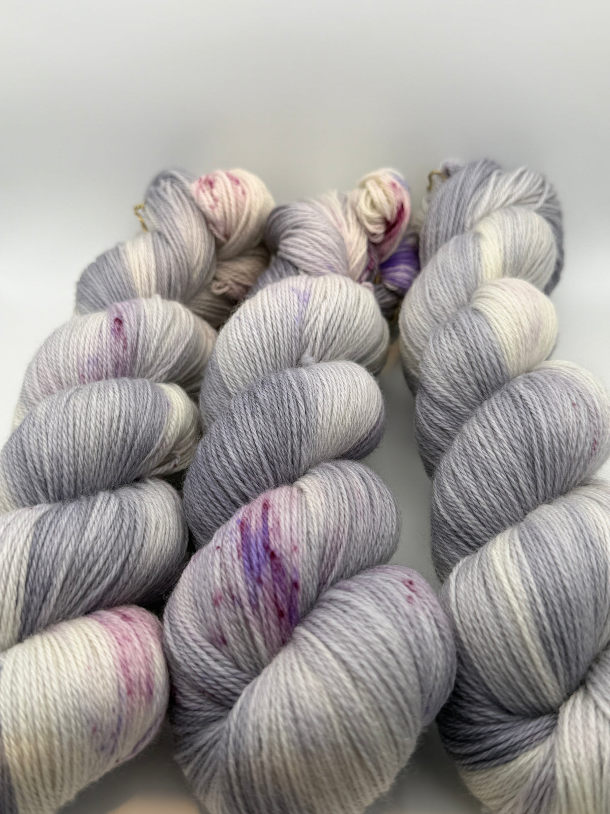 Hand dyed yarn uk, yarn dyed in small batches, geode available in Aran, DK 4 ply, sock, double knit, white, grey, purple tones.