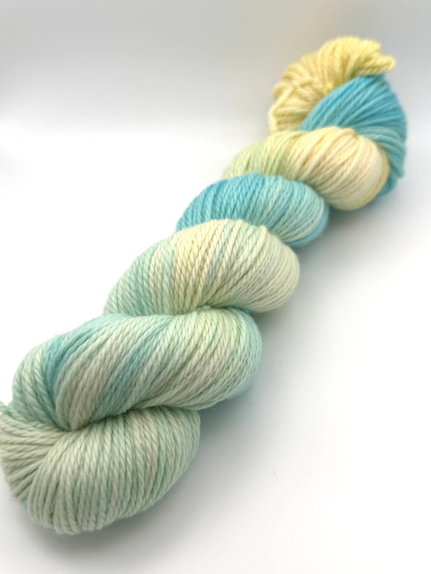 Hand dyed yarn UK available in 4ply sock, aran, DK in Honeydew Sky colourway – Lemon and Blue tones.