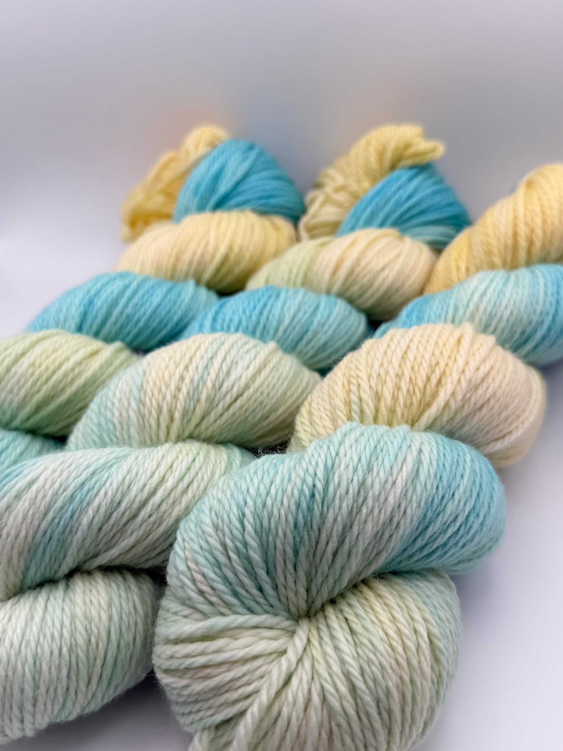 Hand dyed yarn UK available in 4ply sock, aran, DK in Honeydew Sky colourway – Lemon and Blue tones.