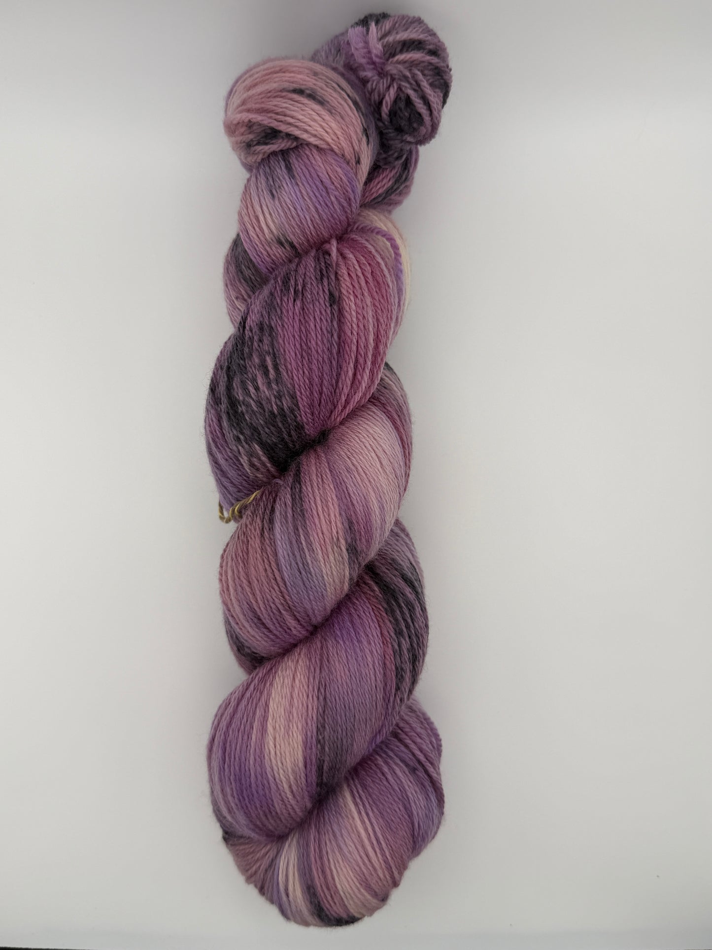 Hand dyed yarn in the UK dyed in small batches. Lilac Skies, purple violet and heather tones.