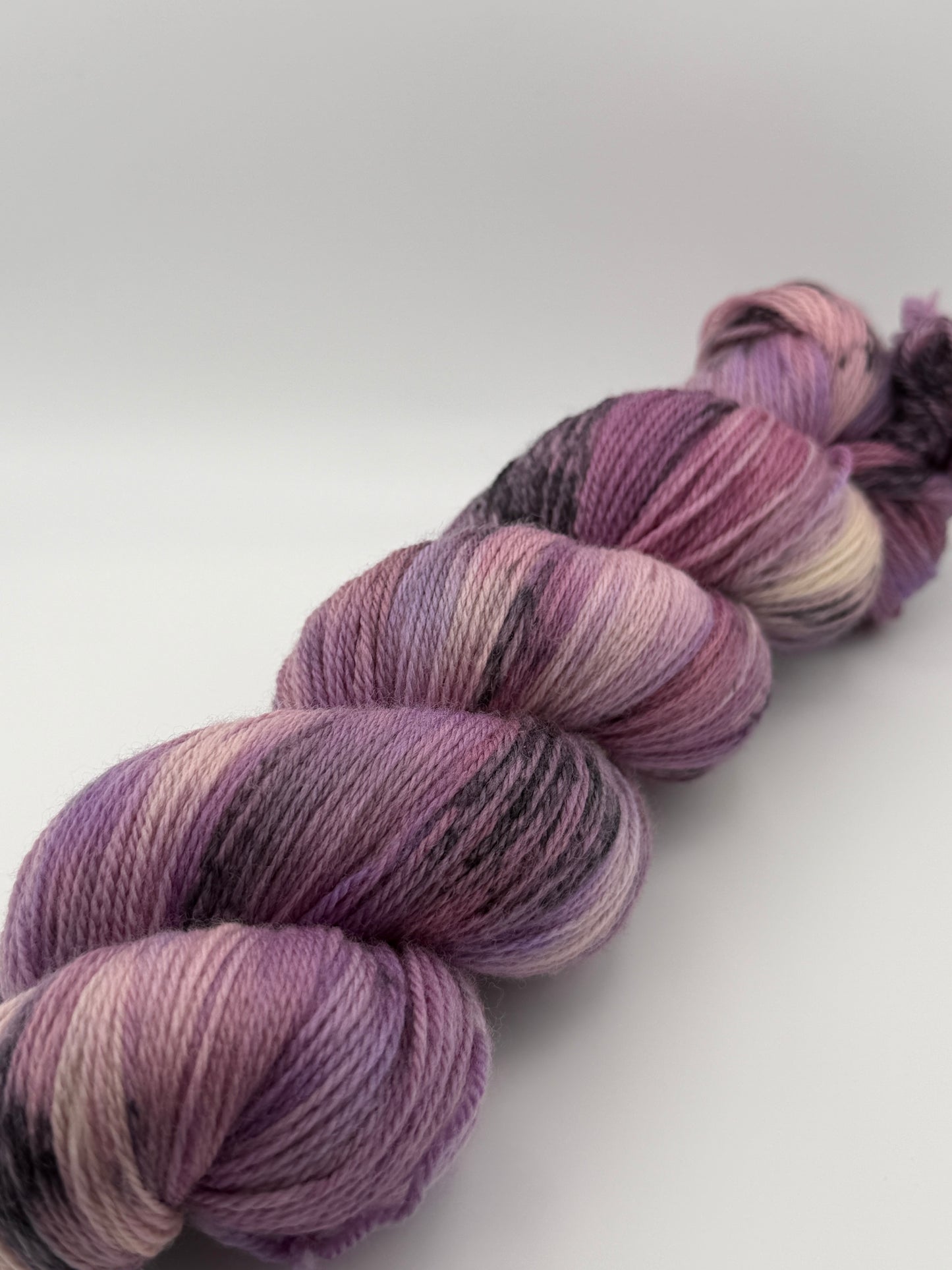 Hand dyed yarn in the UK dyed in small batches. Lilac Skies, purple violet and heather tones.