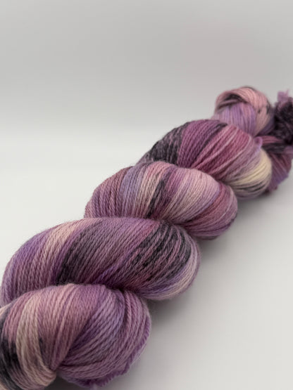 Hand dyed yarn in the UK dyed in small batches. Lilac Skies, purple violet and heather tones.