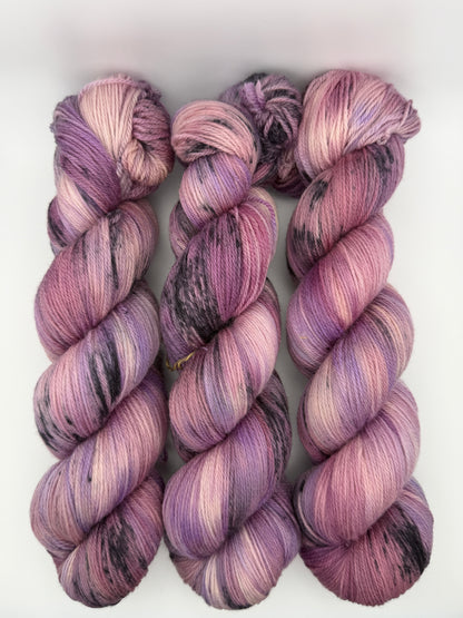 Hand dyed yarn in the UK dyed in small batches. Lilac Skies, purple violet and heather tones.