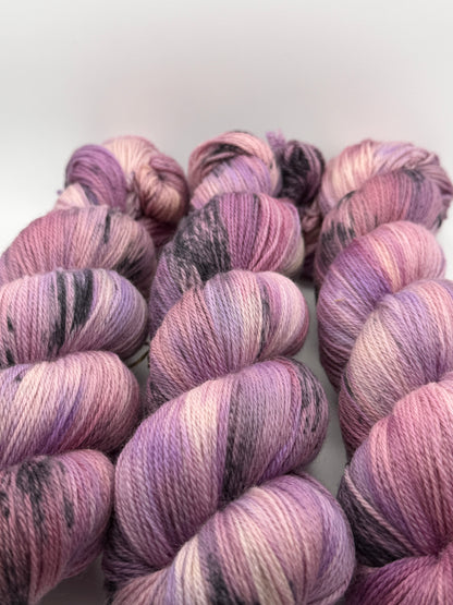Hand dyed yarn in the UK dyed in small batches. Lilac Skies, purple violet and heather tones.