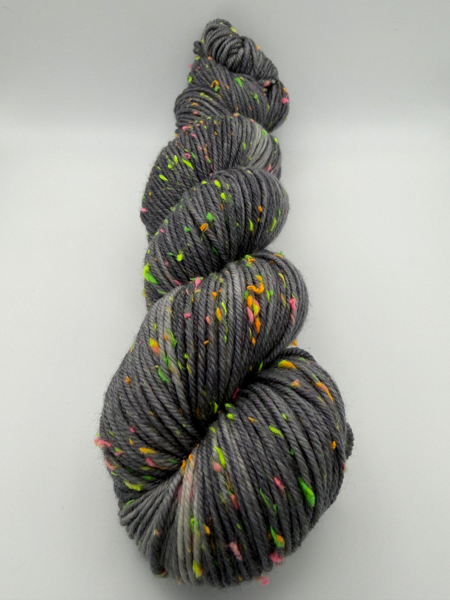Hand dyed yarn in the UK dyed in small batches. Neon Dust, grey tones with neo nep speckles.