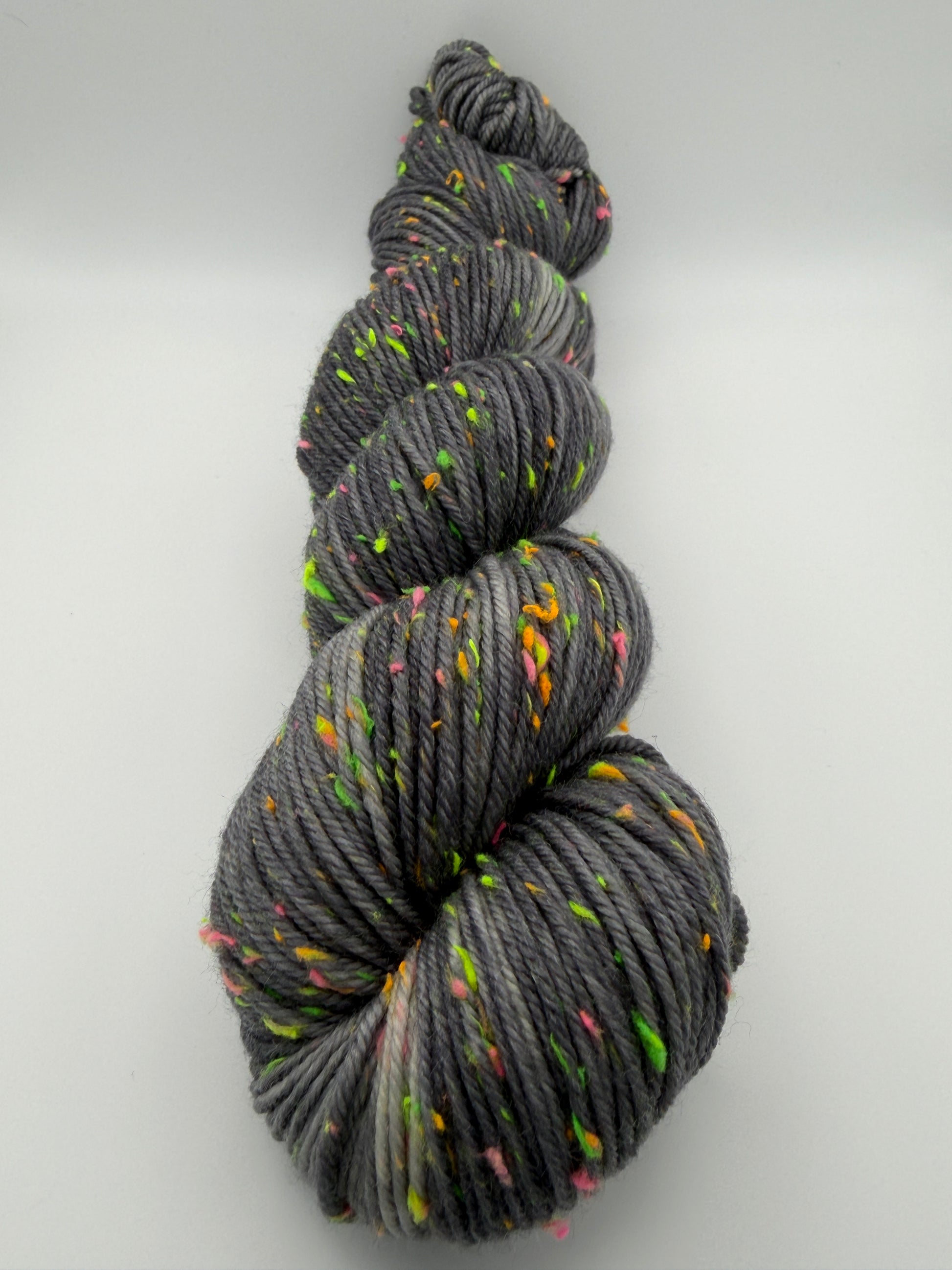 Hand dyed yarn in the UK dyed in small batches. Neon Dust, grey tones with neo nep speckles.