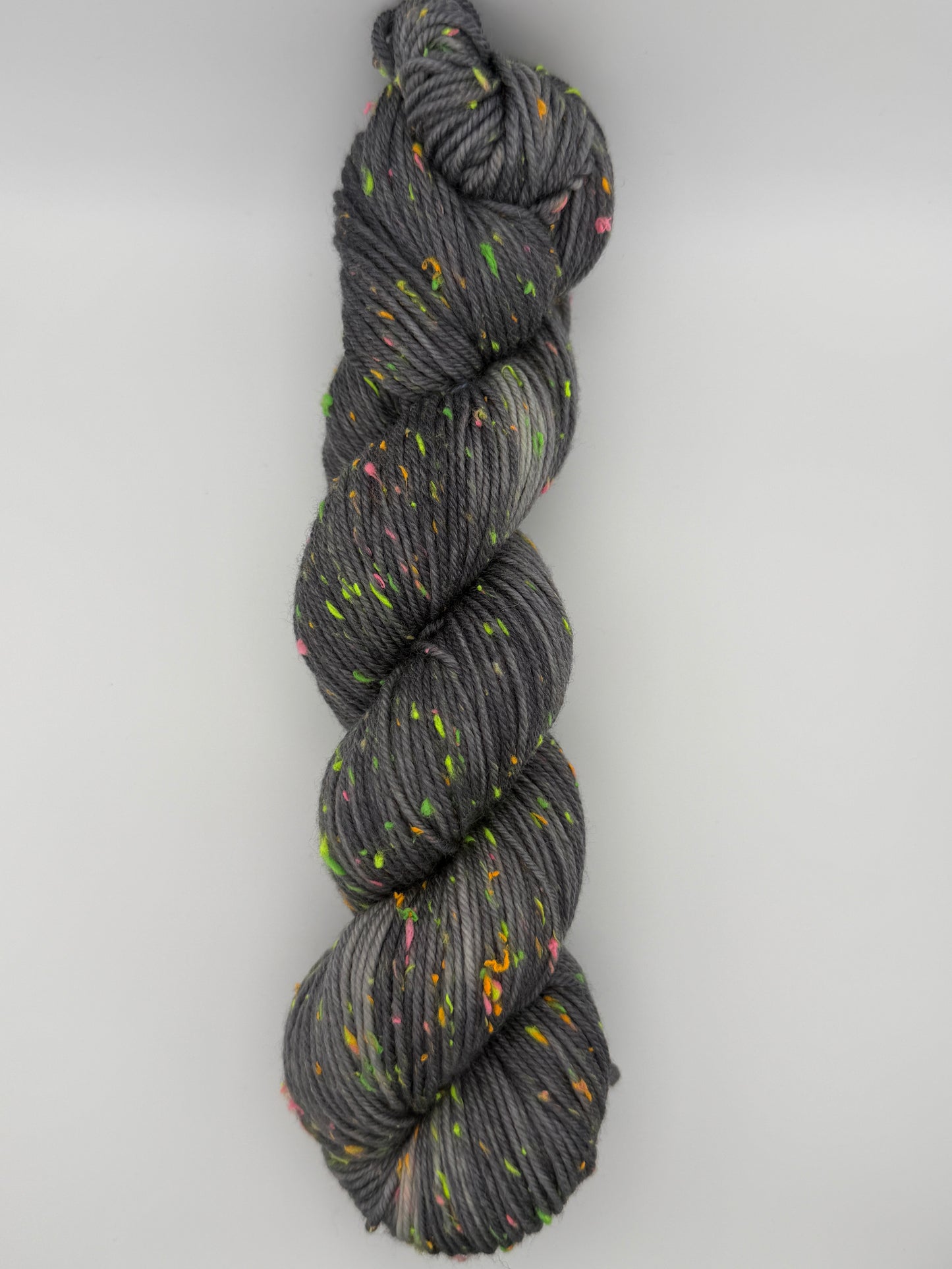 Hand dyed yarn in the UK dyed in small batches. Neon Dust, grey tones with neo nep speckles.