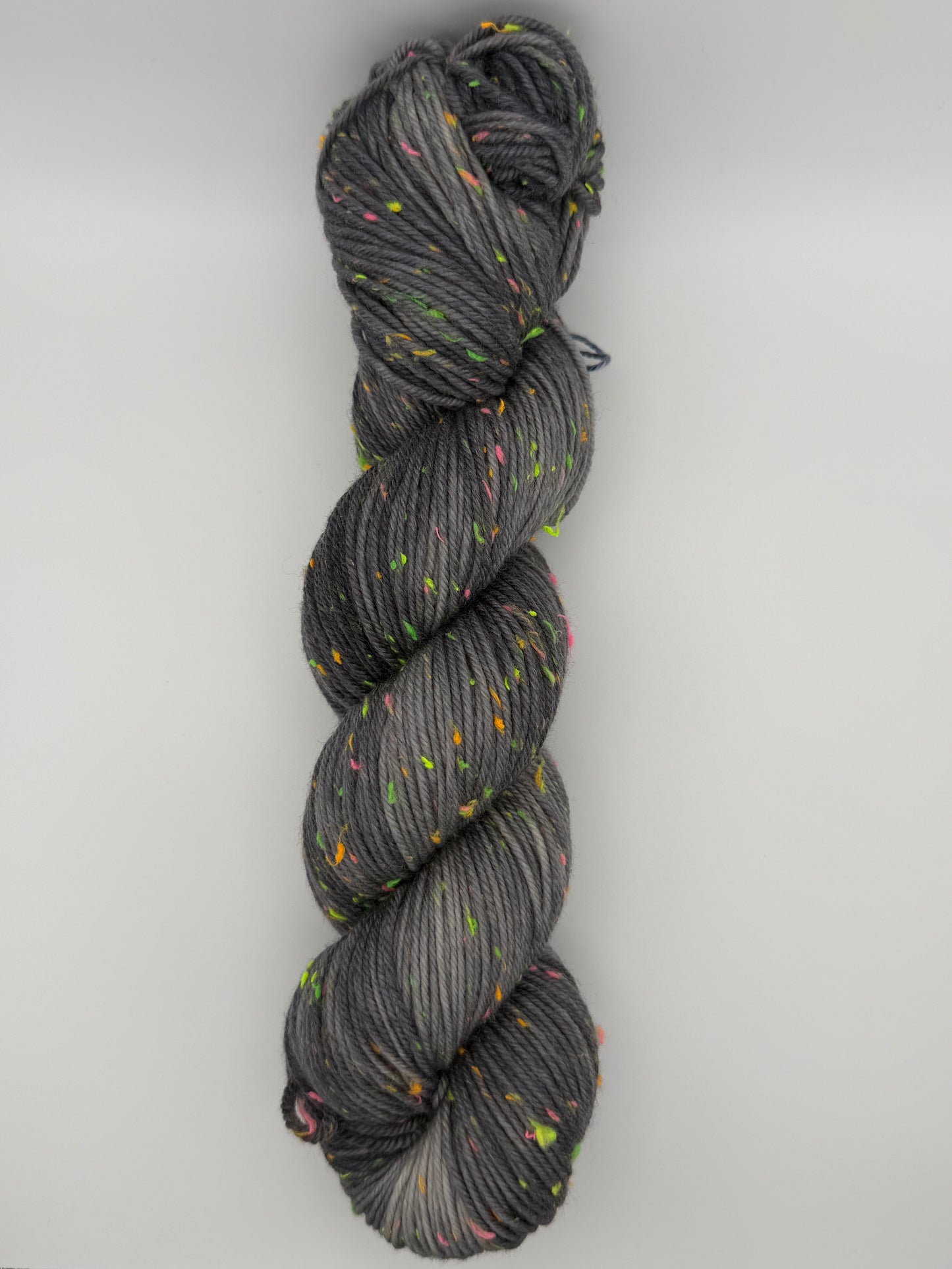 Hand dyed yarn in the UK dyed in small batches. Neon Dust, grey tones with neo nep speckles.