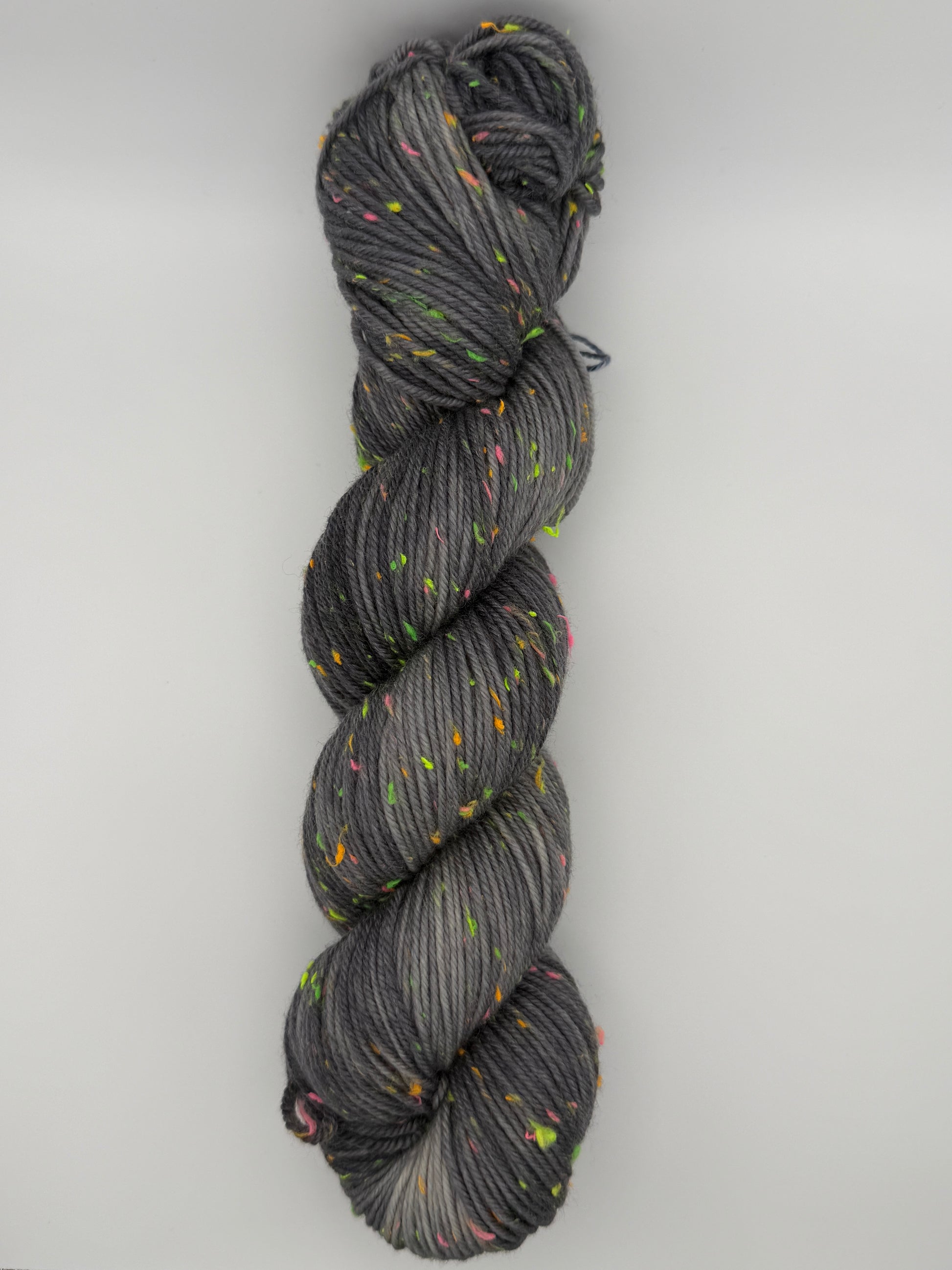 Hand dyed yarn in the UK dyed in small batches. Neon Dust, grey tones with neo nep speckles.