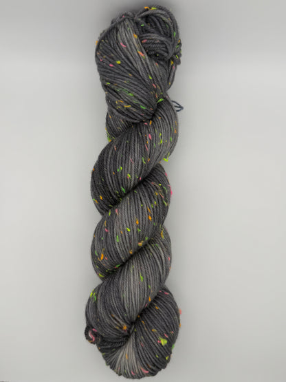Hand dyed yarn in the UK dyed in small batches. Neon Dust, grey tones with neo nep speckles.
