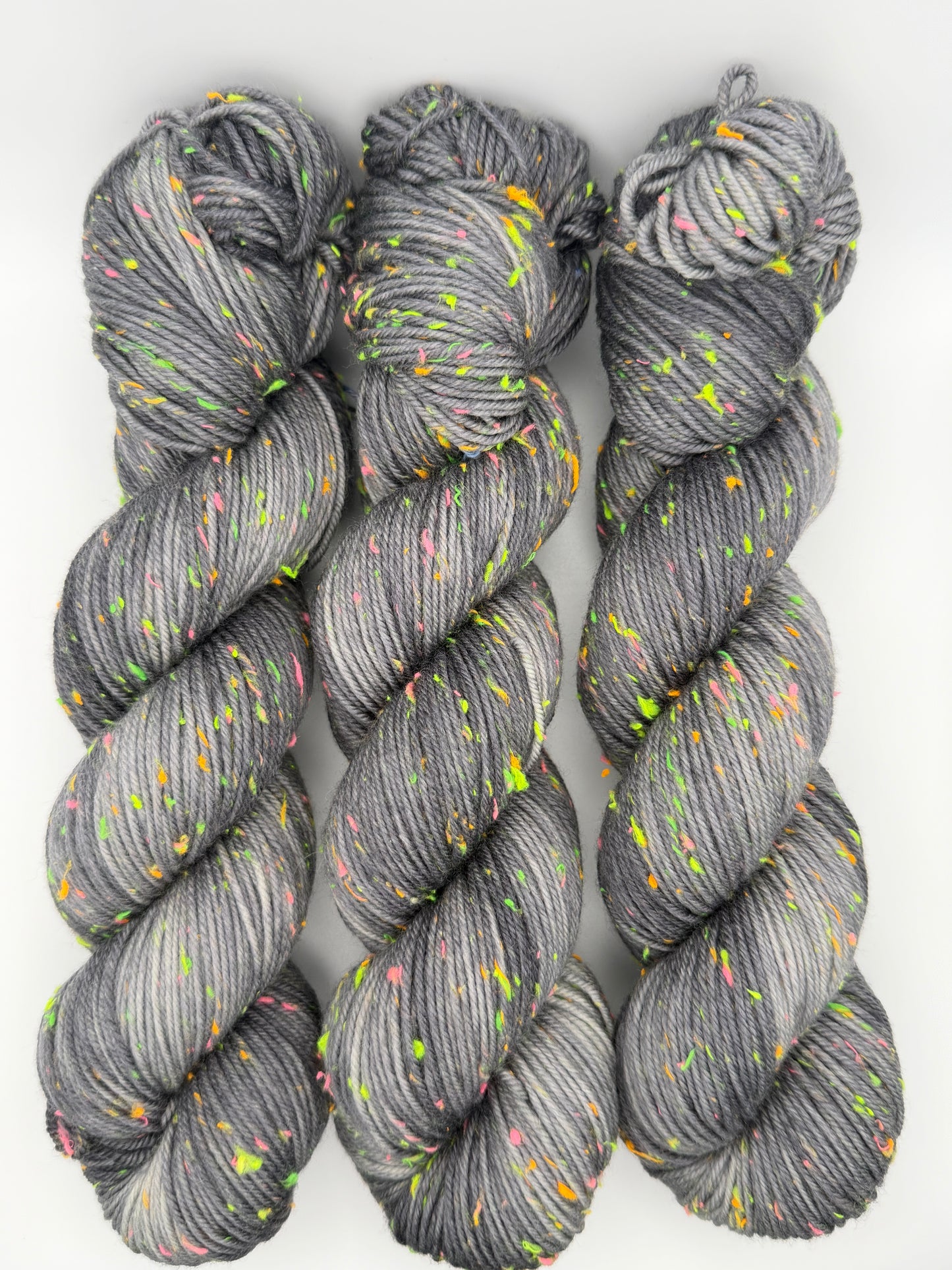 Hand dyed yarn in the UK dyed in small batches. Neon Dust, grey tones with neo nep speckles.