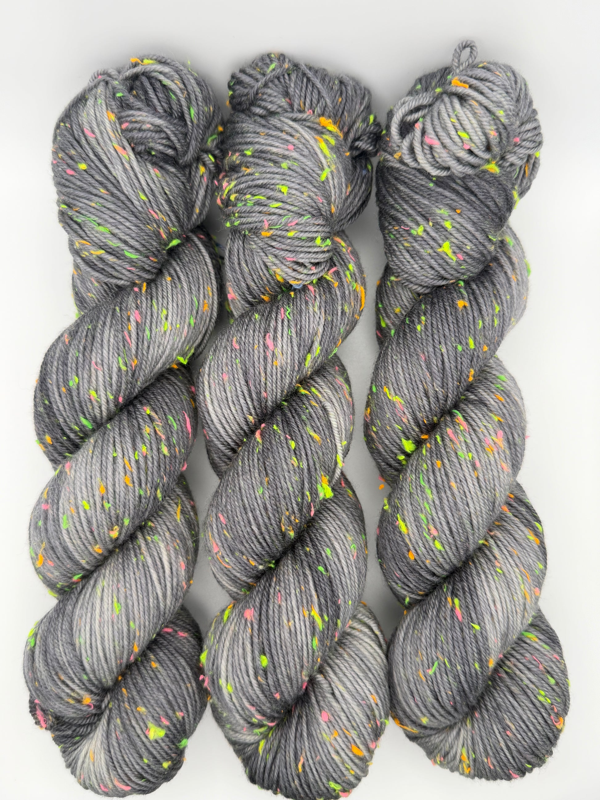 Hand dyed yarn in the UK dyed in small batches. Neon Dust, grey tones with neo nep speckles.