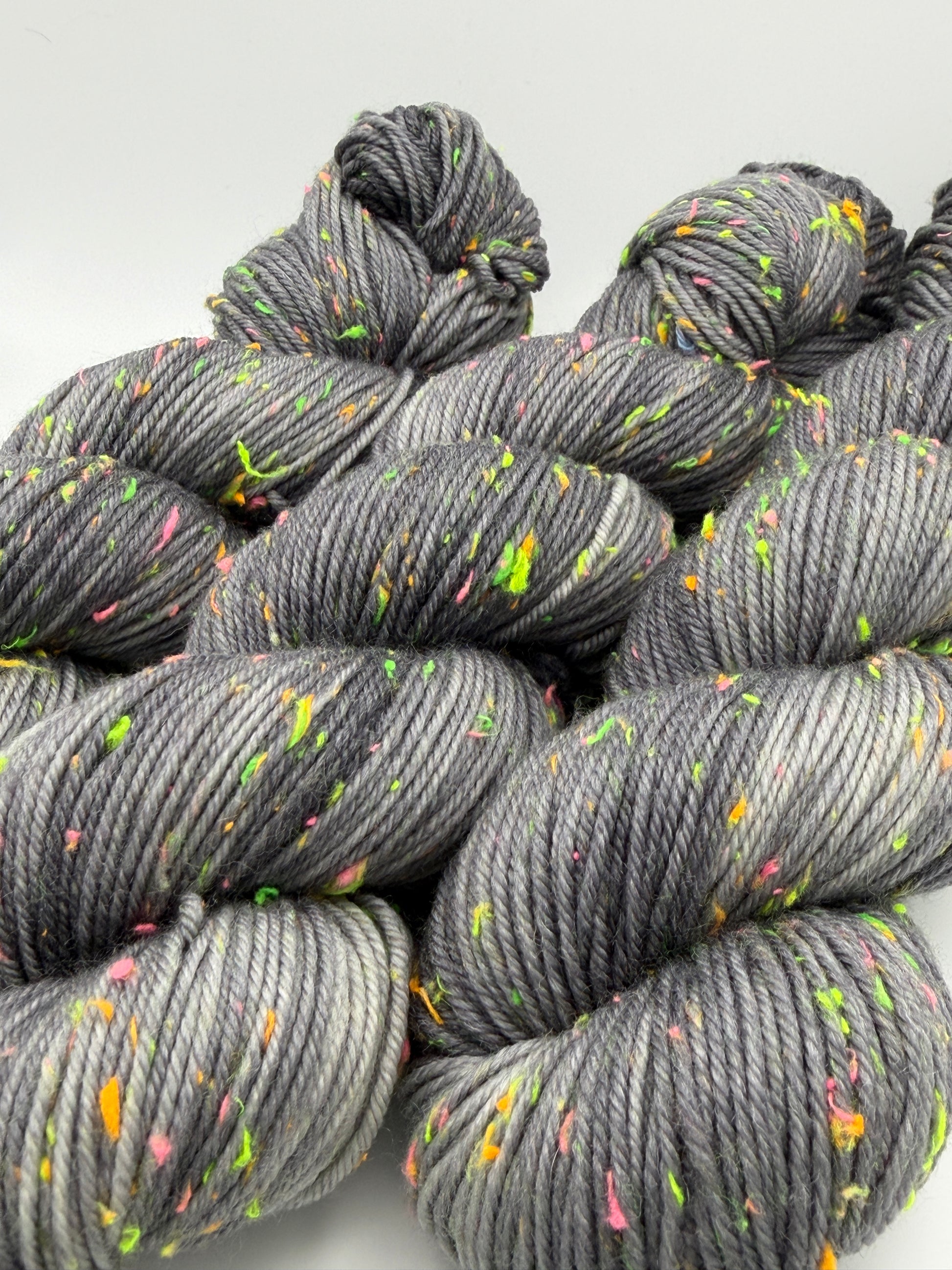 Hand dyed yarn in the UK dyed in small batches. Neon Dust, grey tones with neo nep speckles.