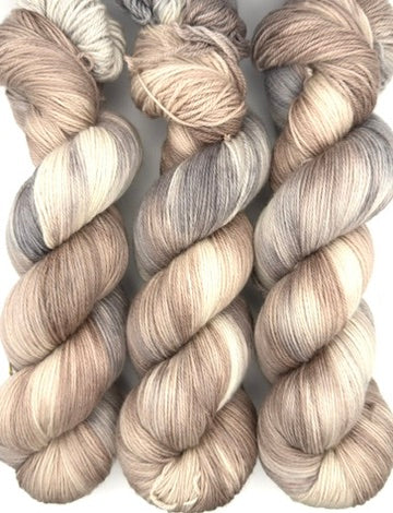 Hand dyed yarn UK available in 4ply sock, aran, DK in Pebble Shore colourway – neutral and grey tones.