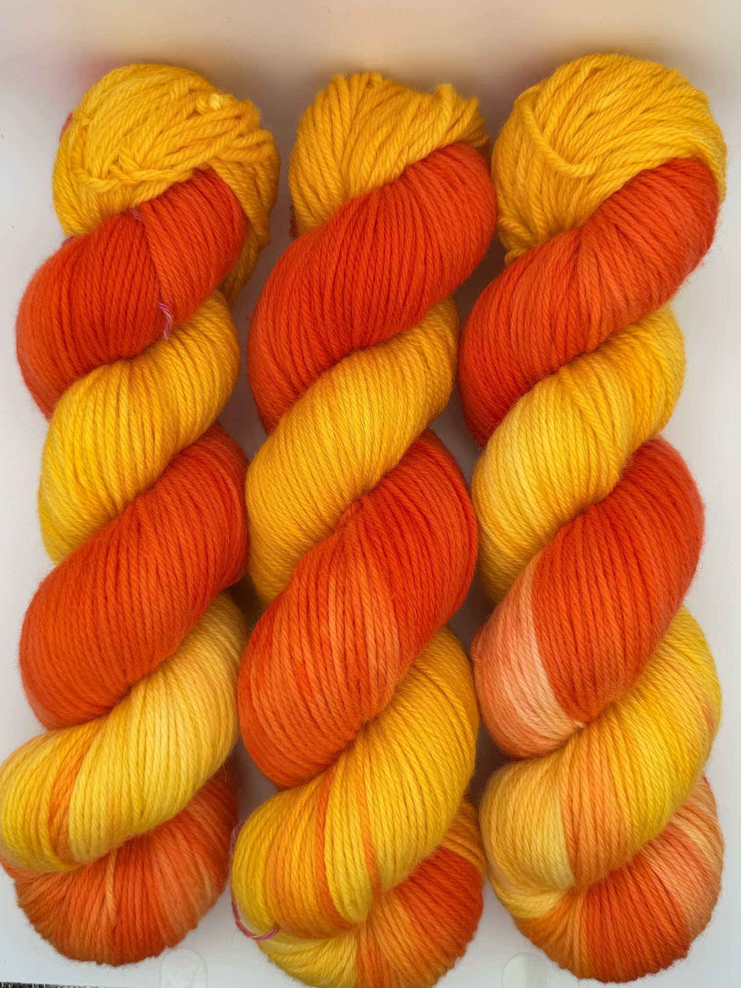 Hand dyed yarn available in 4ply sock, DK, Aran in Tequila Sunrise colourway – yellow  and orange tones