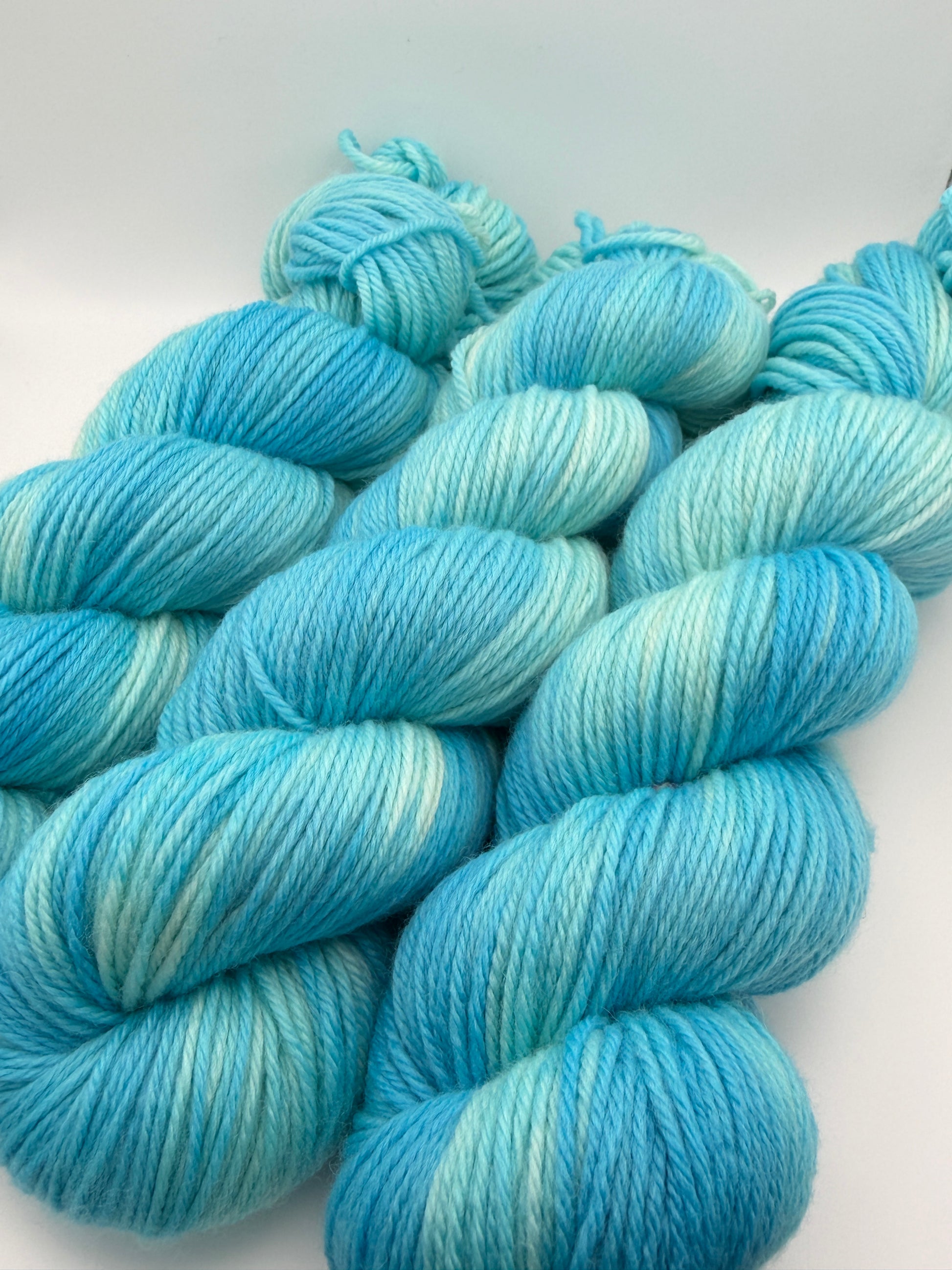 Hand dyed yarn available in 4ply sock, aran, DK in Blue Lagoon colourway – blue, teal, aqua tones