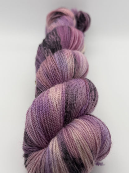 Hand dyed yarn in the UK dyed in small batches. Lilac Skies, purple violet and heather tones.