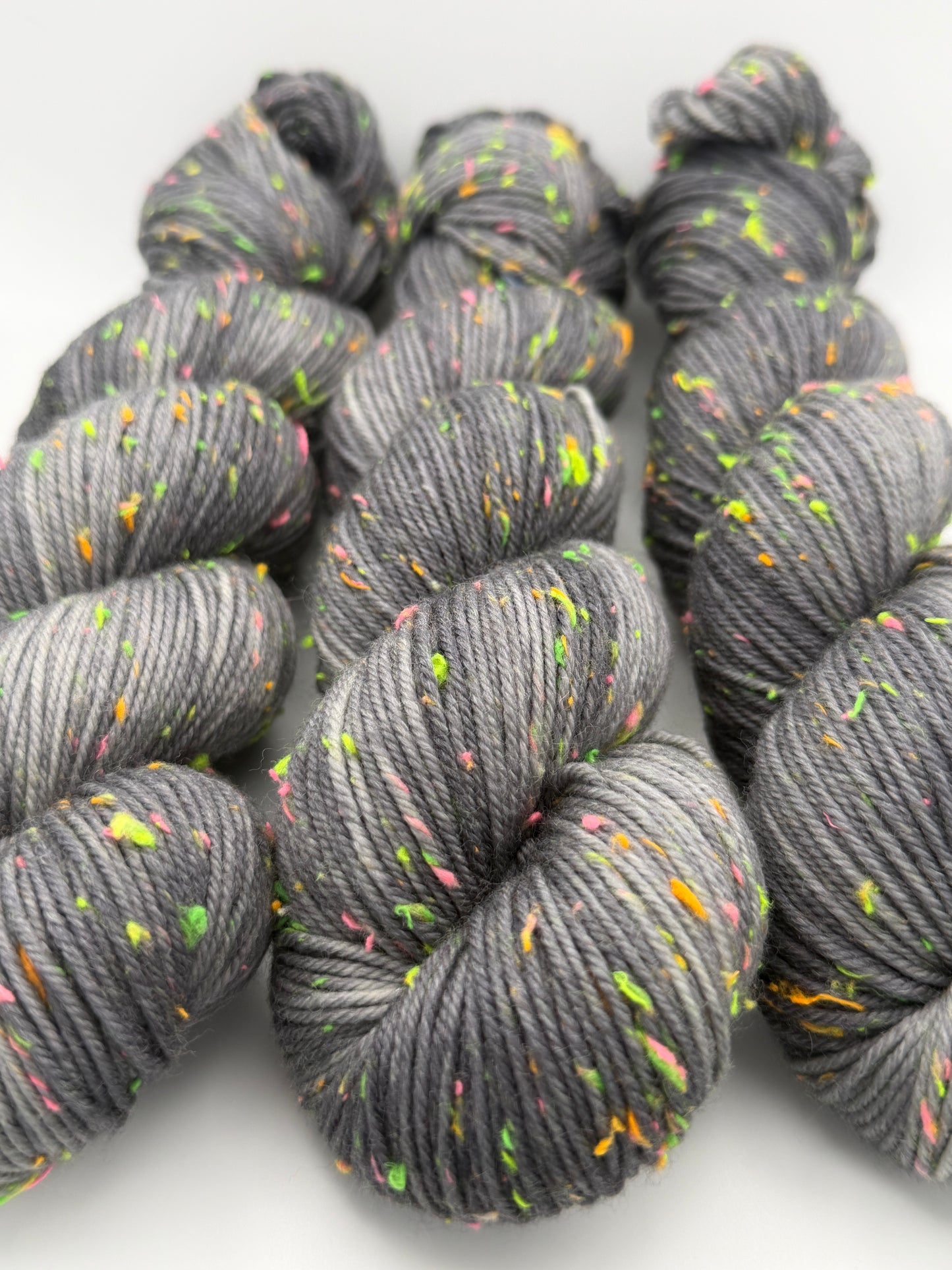 Hand dyed yarn in the UK dyed in small batches. Neon Dust, grey tones with neo nep speckles.