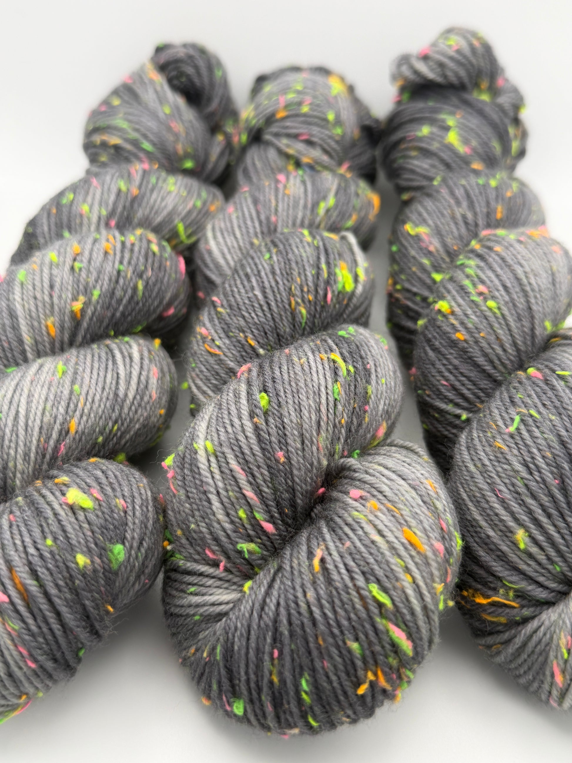 Hand dyed yarn in the UK dyed in small batches. Neon Dust, grey tones with neo nep speckles.