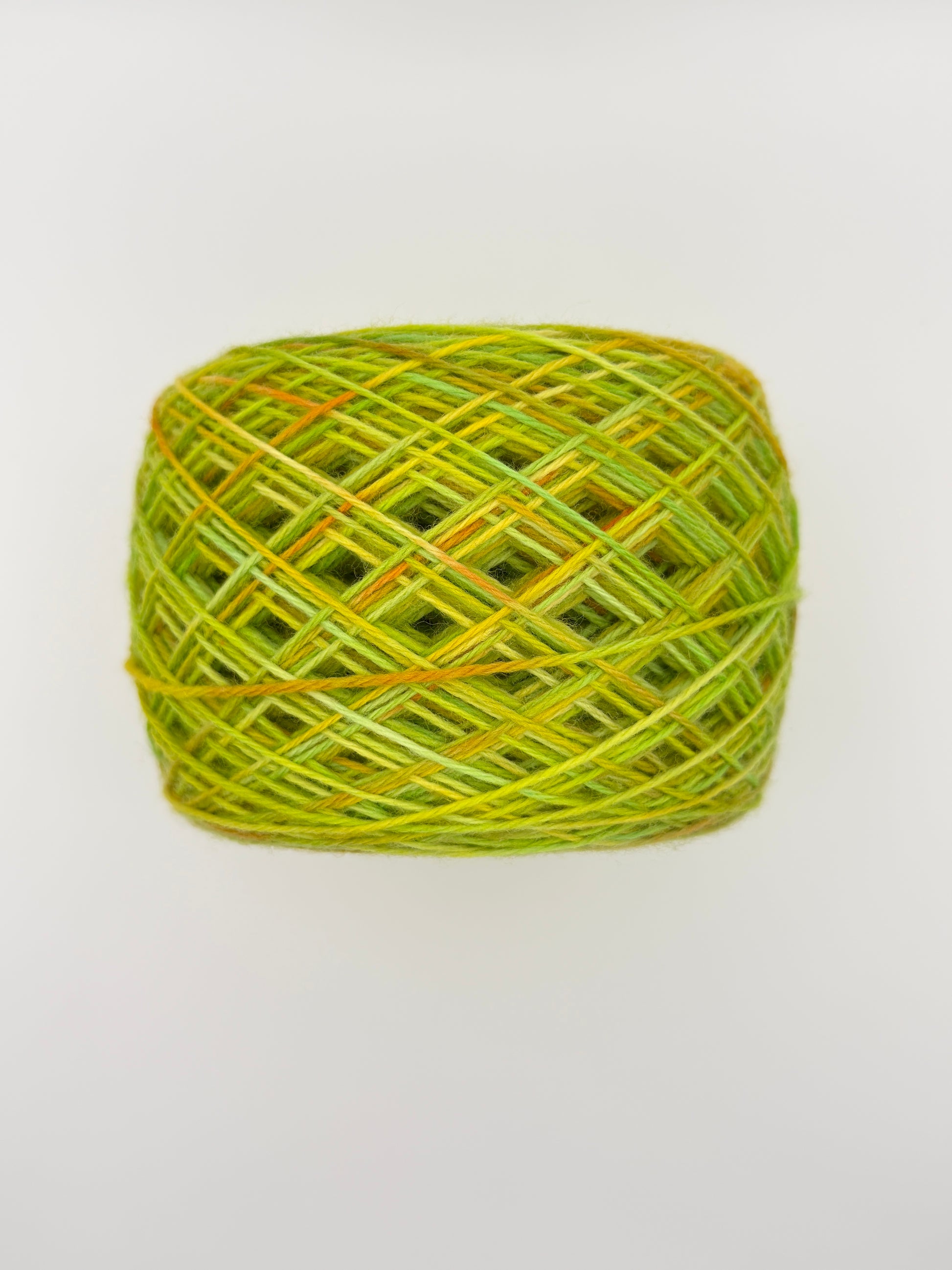 Hand dyed yarn available in 4ply sock, aran, DK in Sour Candy colourway – green and yellow tones with orange speckled yarn