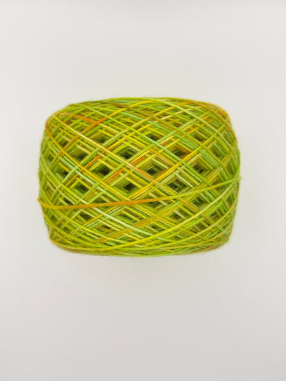 Hand dyed yarn available in 4ply sock, aran, DK in Sour Candy colourway – green and yellow tones with orange speckled yarn