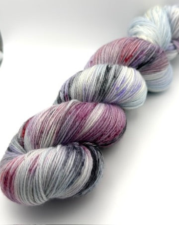 Hand dyed yarn UK available in 4ply sock, aran, DK in Very Berry colourway – blue, purple and neutral tones.