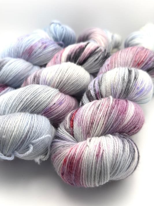 Hand dyed yarn UK available in 4ply sock, aran, DK in Very Berry colourway – blue, purple and neutral tones.