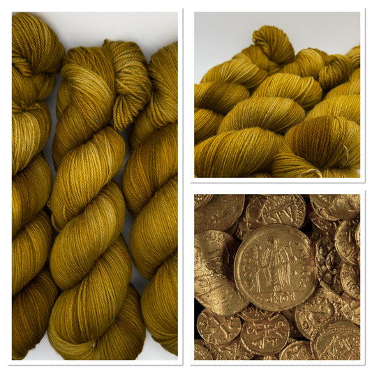 A pile of ancient gold coins, the inspiration for Old Gold hand dyed yarn
