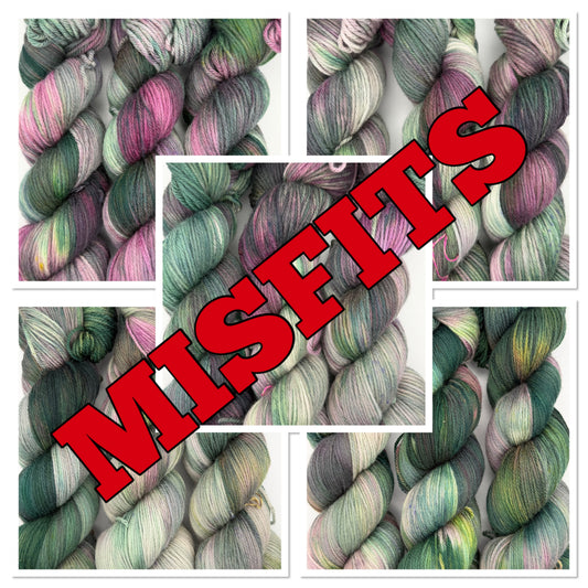 Thistle Misfits hand dyed merino yarn in mixed green, pink and grey, showing the variation between one of a kind skeins